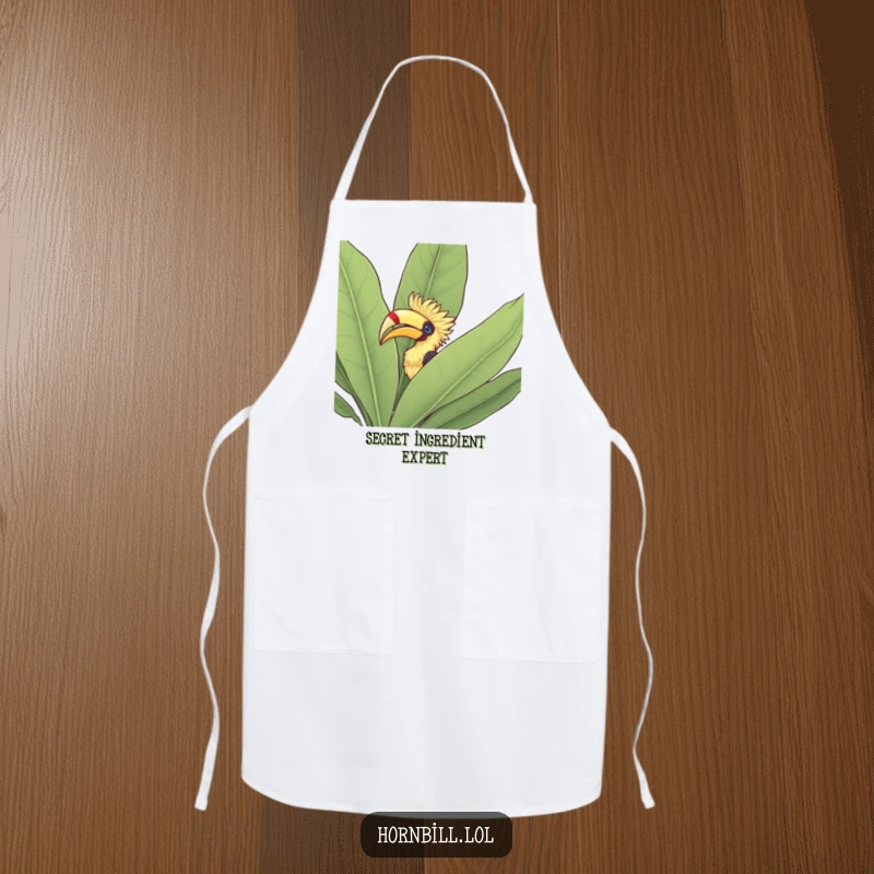 Funny Apron: Hornbill peeking its head out from behind a large leafy bush, a curious kitchen companion.