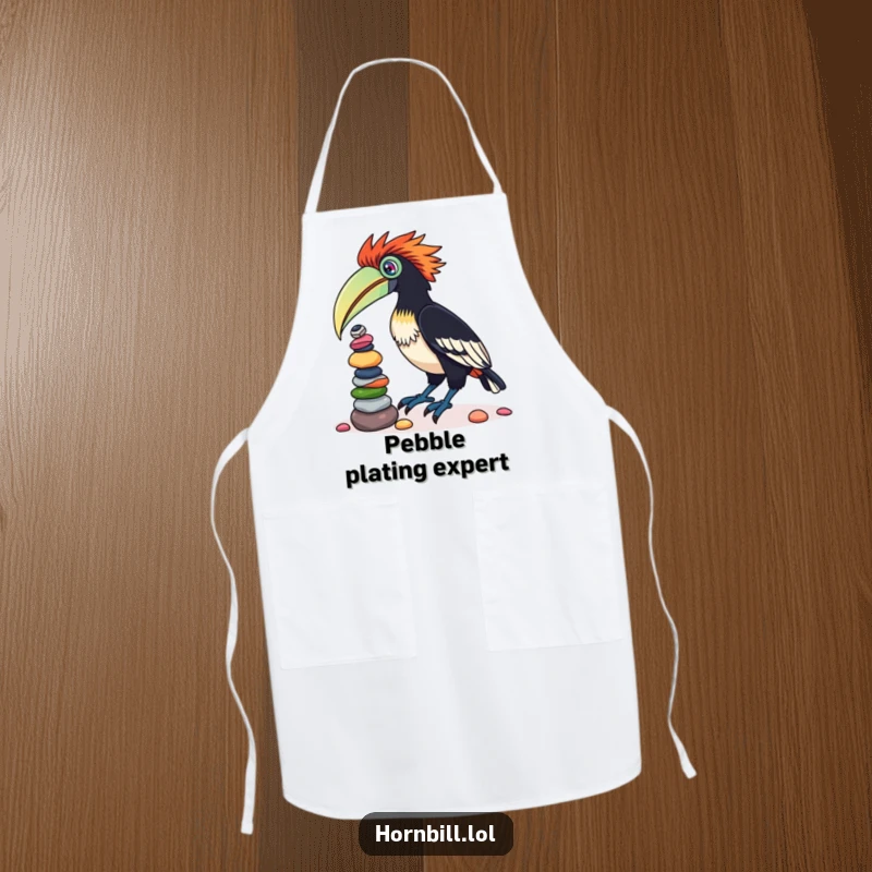 Funny apron showing a determined hornbill bird with a chef's look, masterfully balancing a stack of colorful pebbles on its beak while cooking.