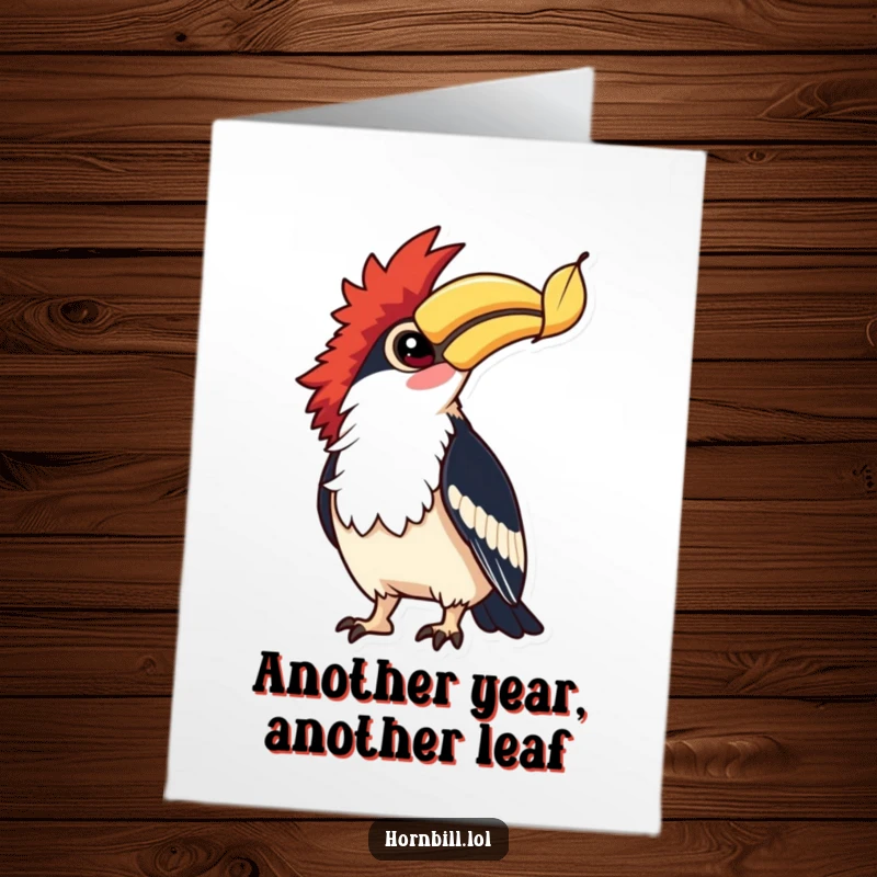 Free Printable Birthday Card: Hornbill with bright eyes gazes up at a falling leaf, capturing a moment of curiosity.