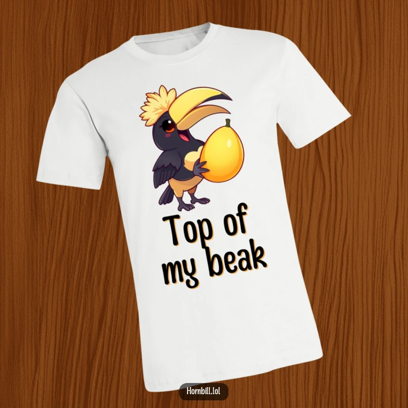 Funny T-Shirt: A delighted hornbill sports a tiny feathered cap while joyfully holding a large, juicy fruit.