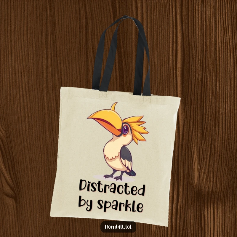 Funny tote bag with a hornbill bird curiously tilting its head towards a small, reflective, shiny object, perfect for carrying treasures.